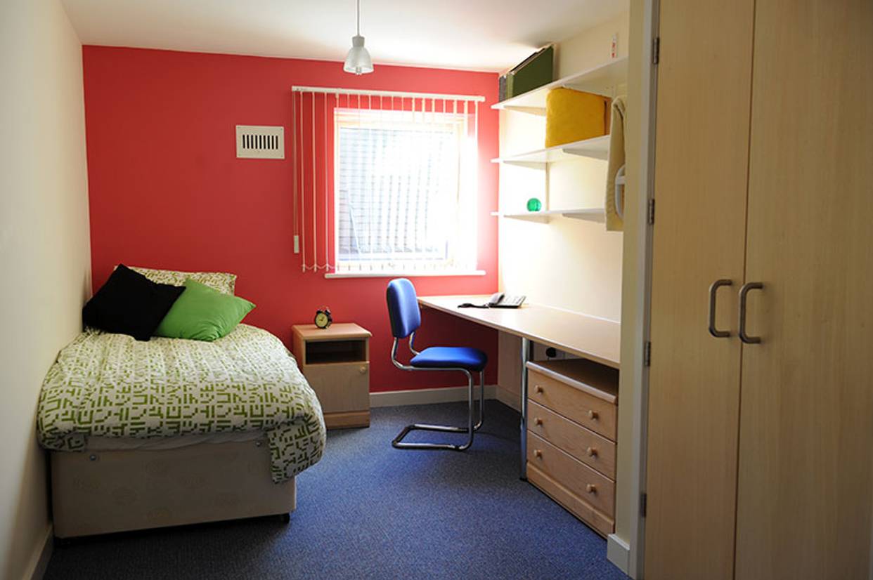 A student bedroom with red walls