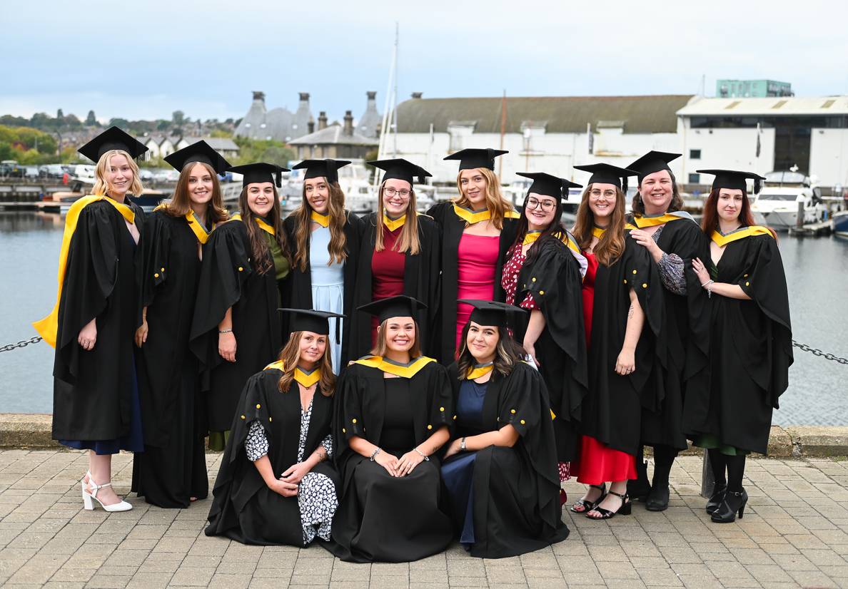 A group of students dressed in graduation robes