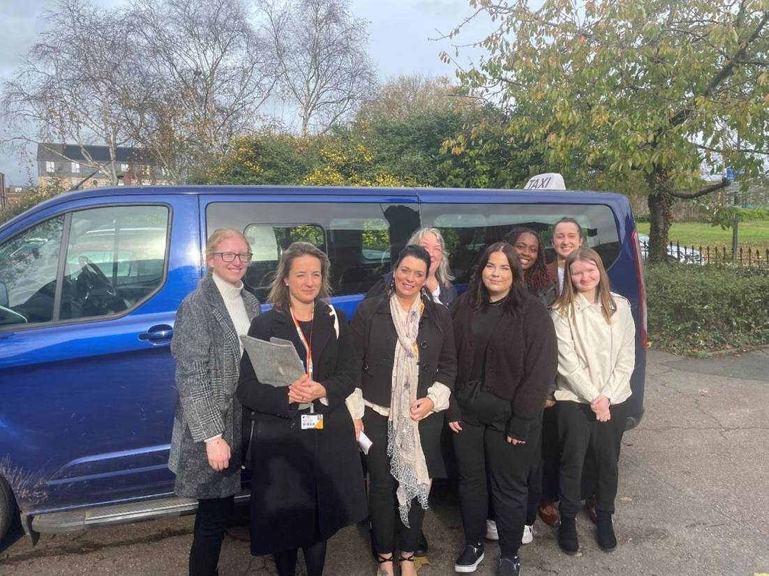 Legal Advice Centre director Eleanor Scarlett and students outside of a van on a trip.