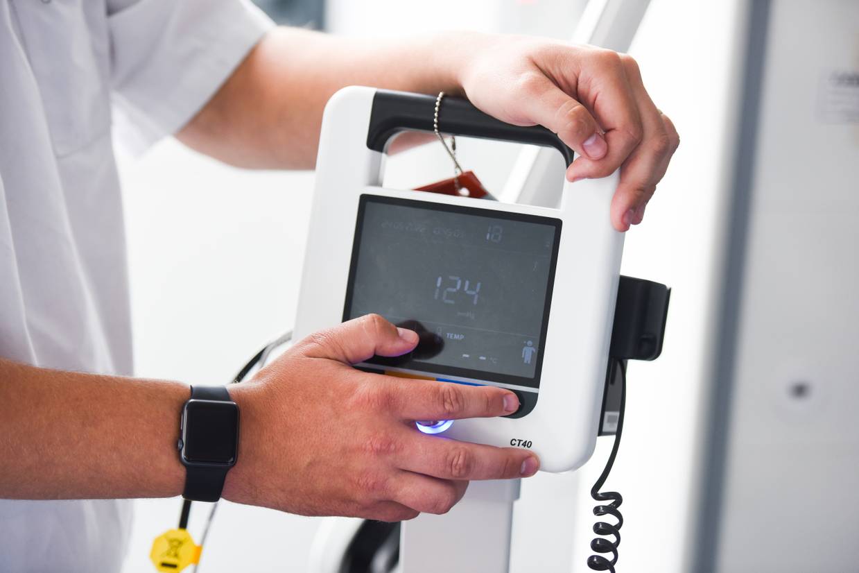 Close-up of someone holding a blood pressure monitor