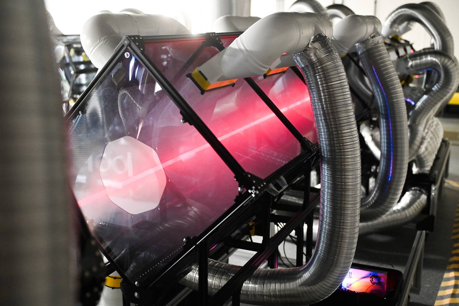 The laser being fired through one of the modular units in the QOD Lab