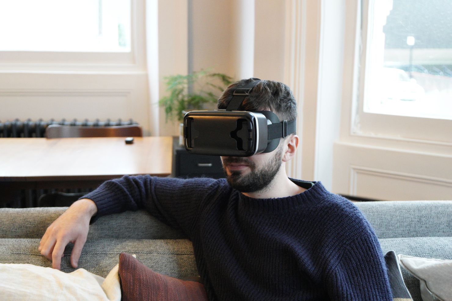 A man wearing a VR headset, watching a VR theatre performance. Photo credit: Eunji Jeong