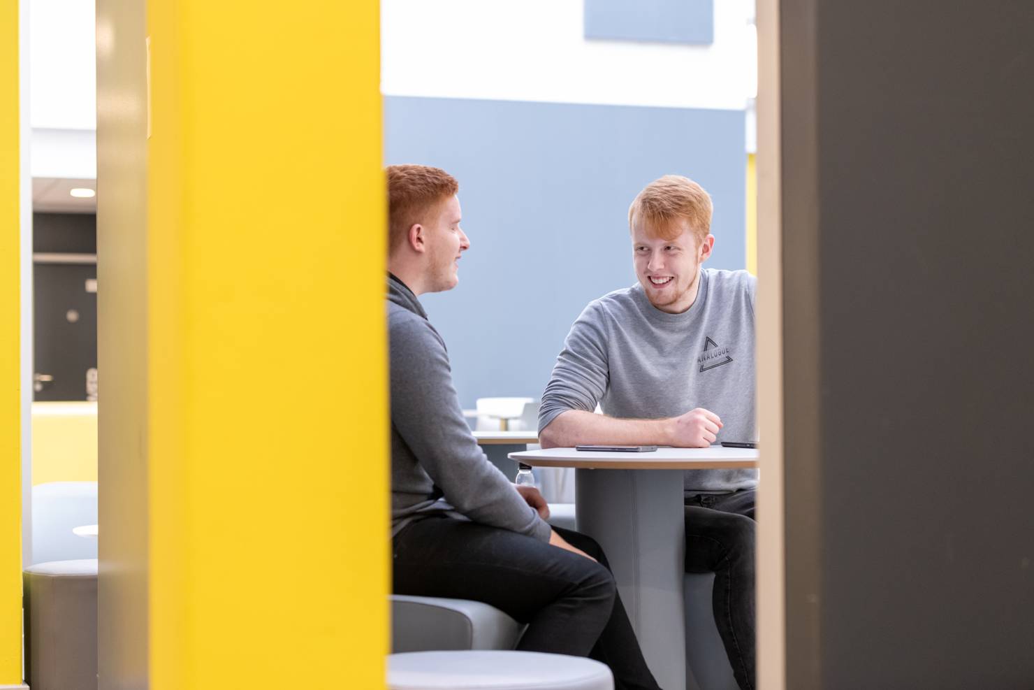 Two students sitting in The Atrium