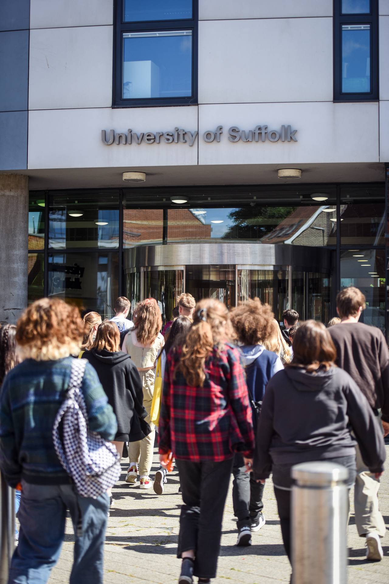 A crowd of student entering the Waterfront Building