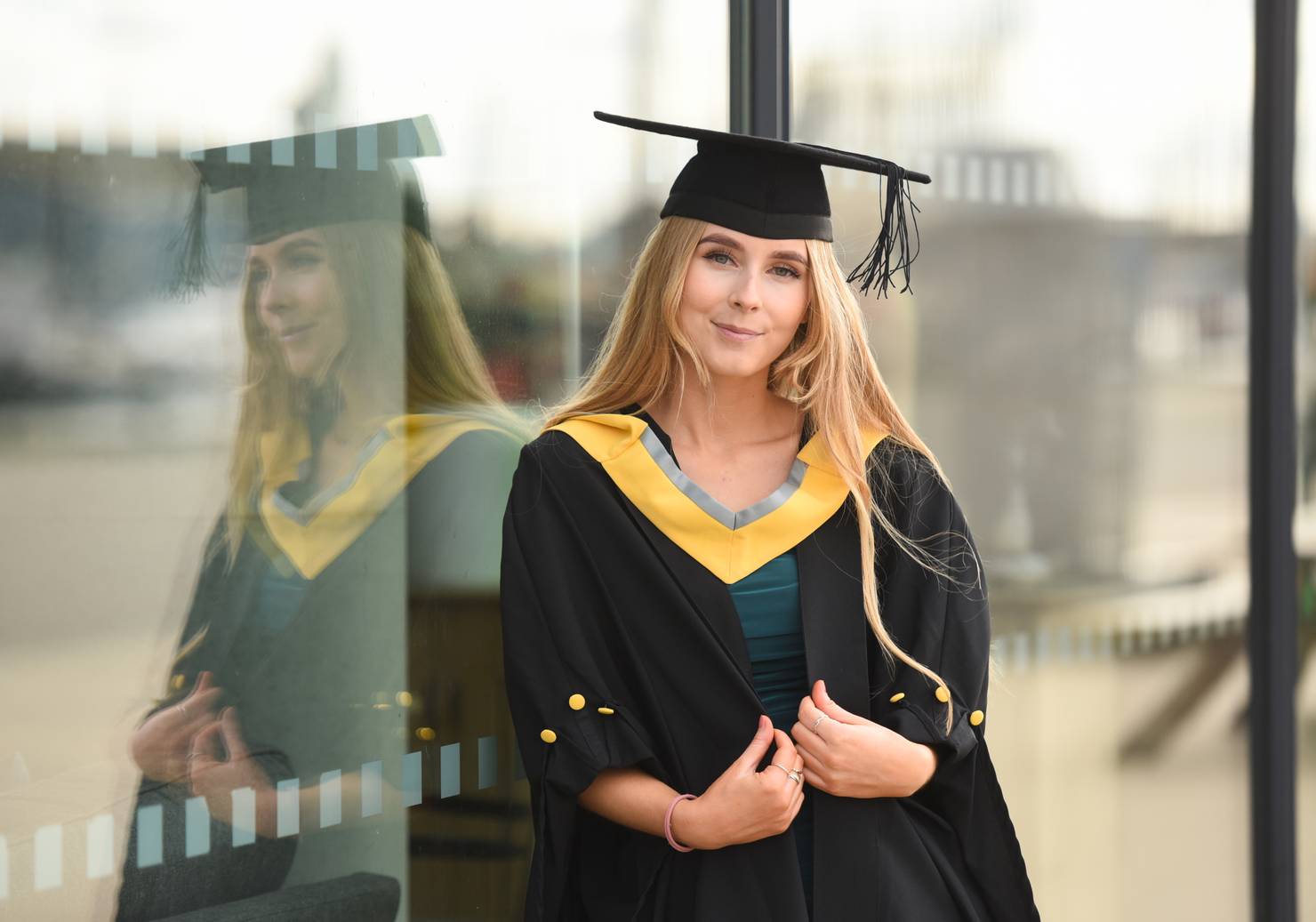 A student leaning against a window