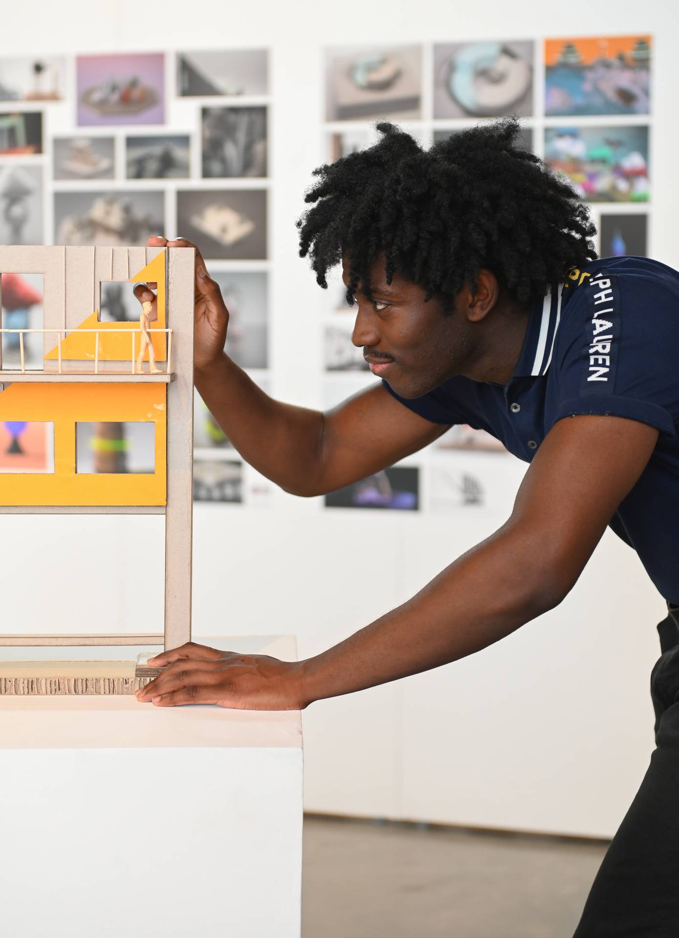 A student looking at an architectural model