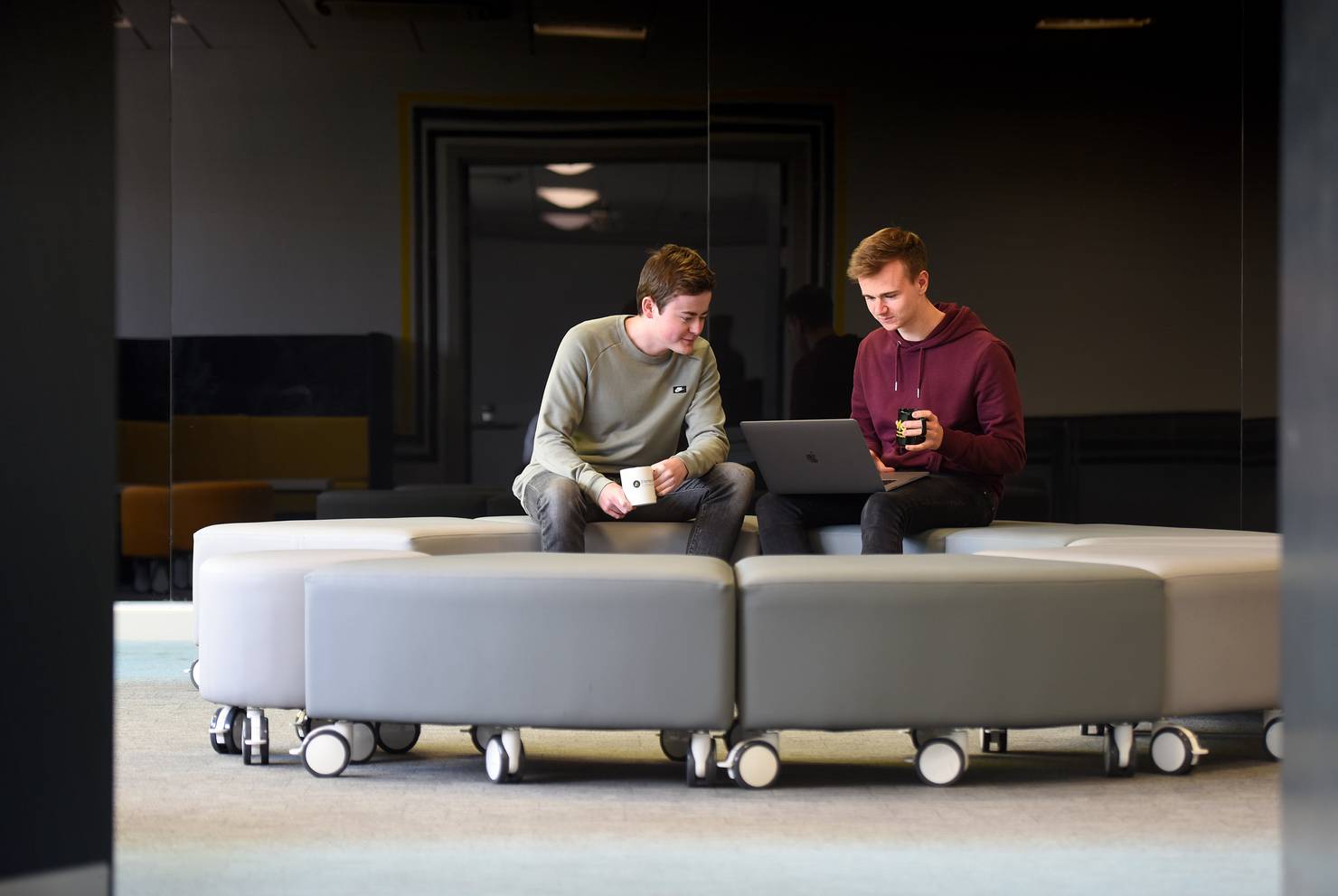 Two students sitting in the Ideas room