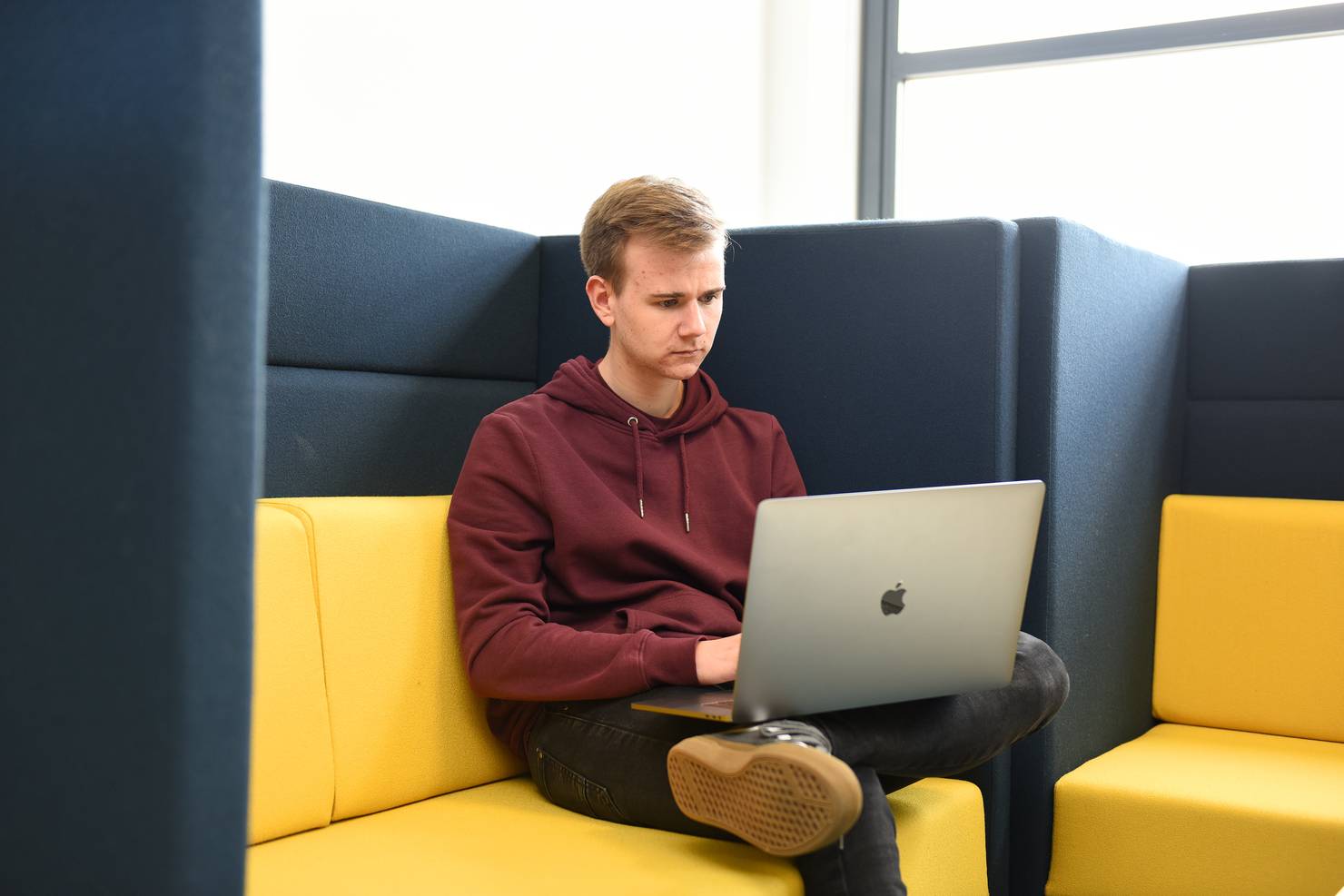 A student sitting with a laptop