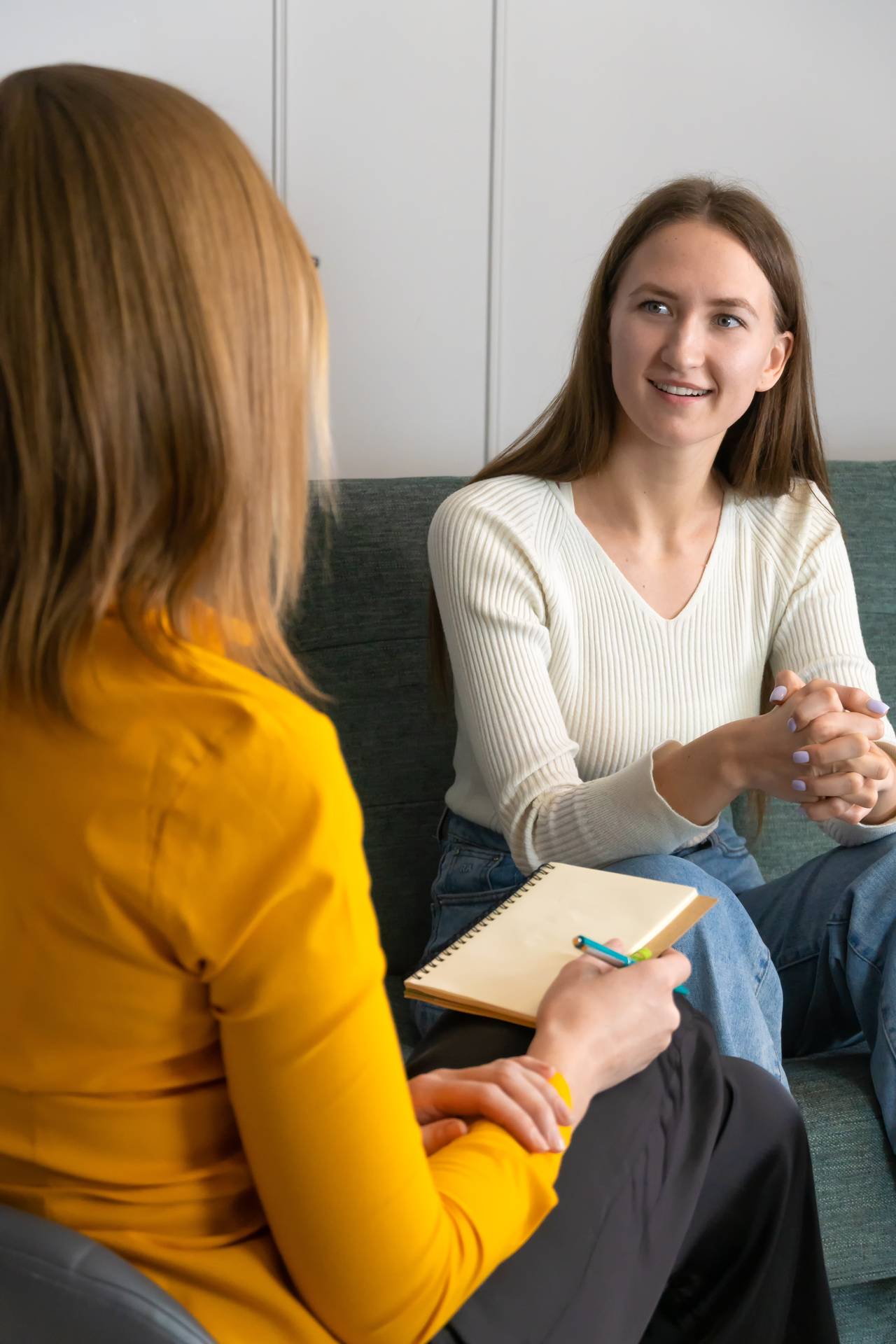Women sitting talking to a counsellor/therapist