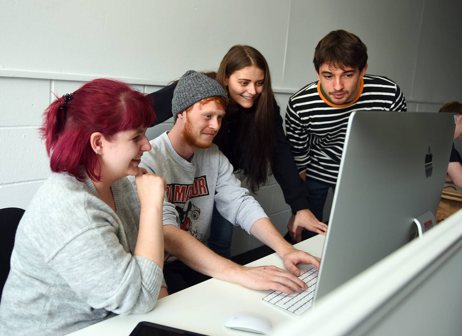 Students working looking at computer in the Lightroom