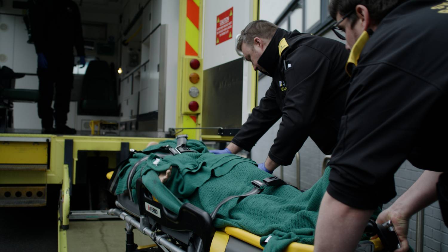 Paramedic student with ambulance