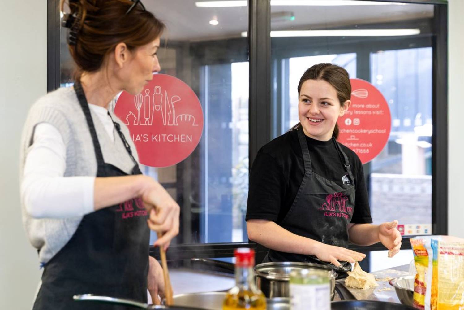 Two students cooking in kitchen