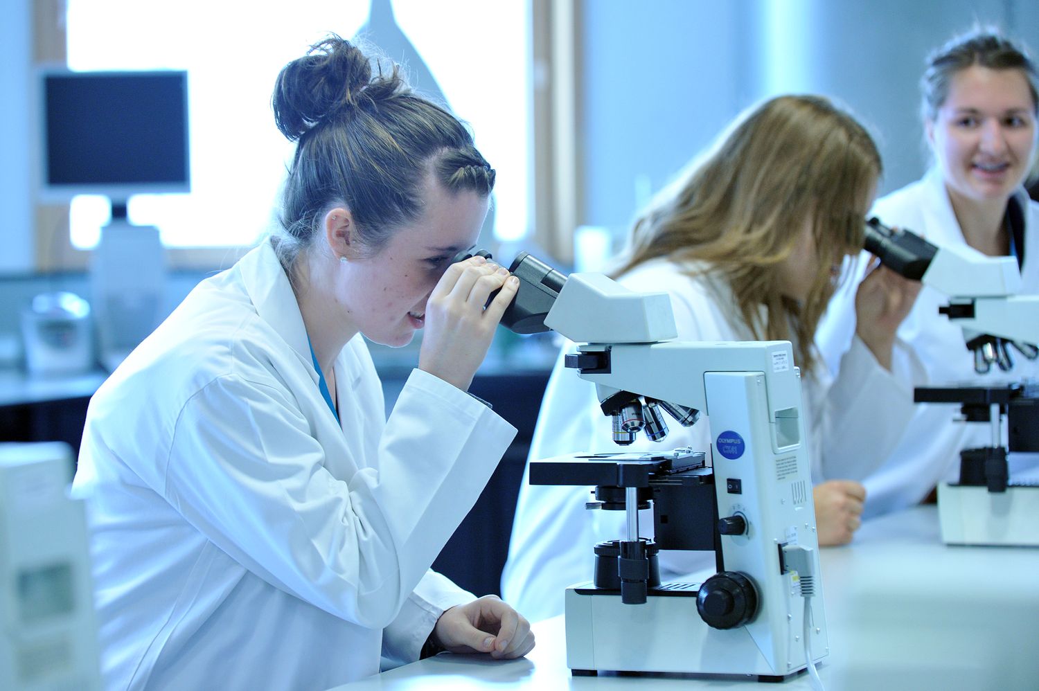 A student looking through a microscope