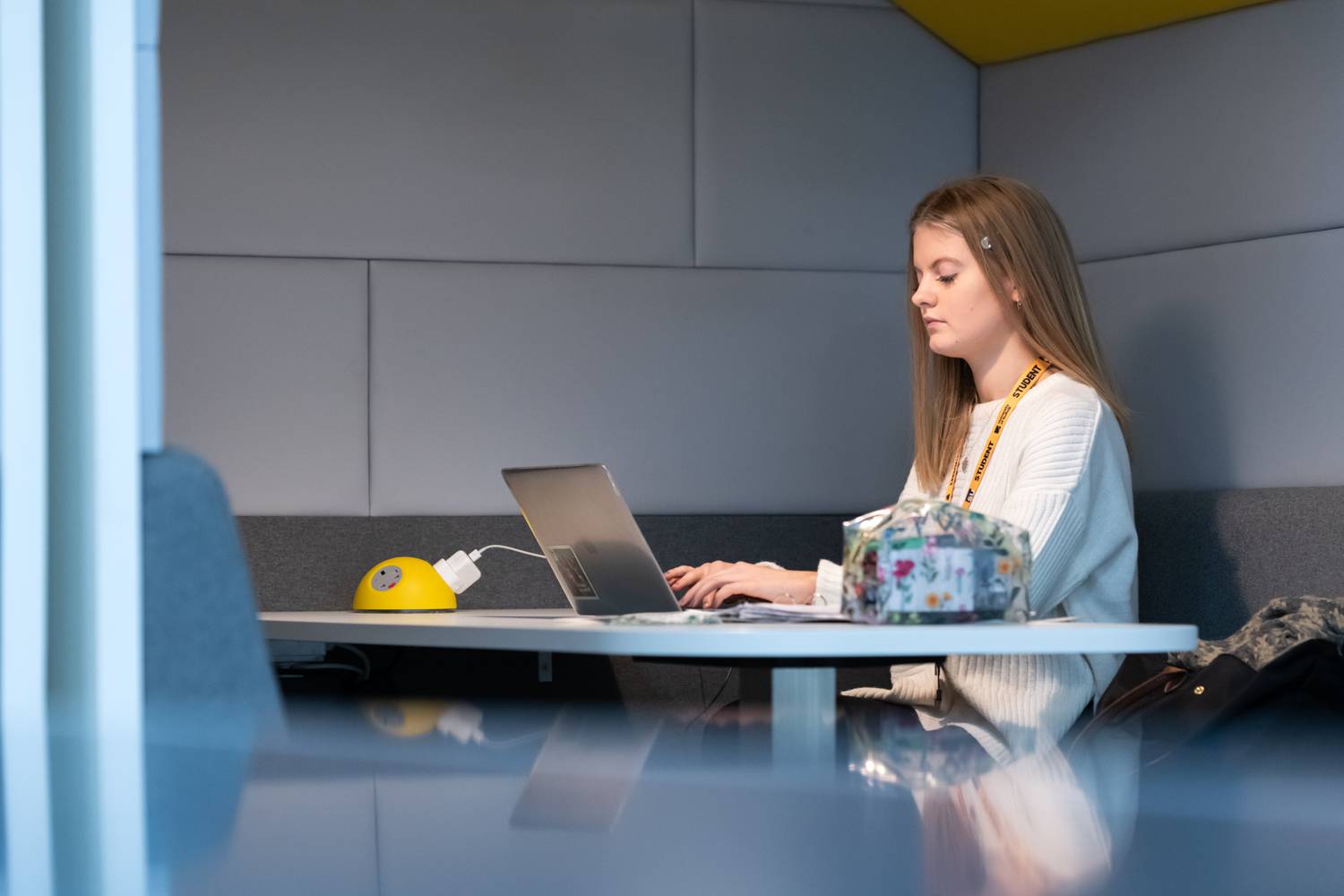 A student sitting with a laptop