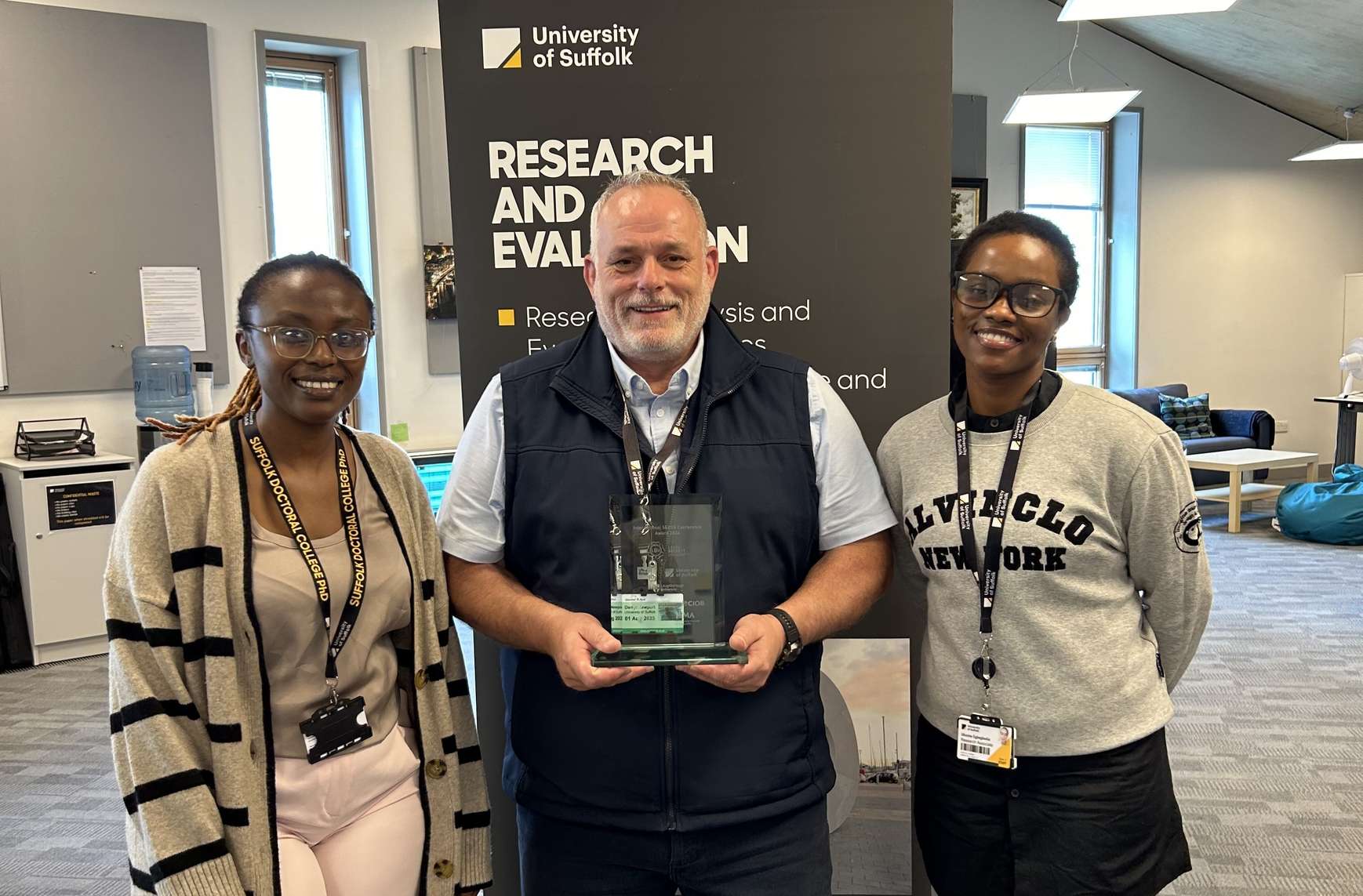 two students receiving an award for their research paper