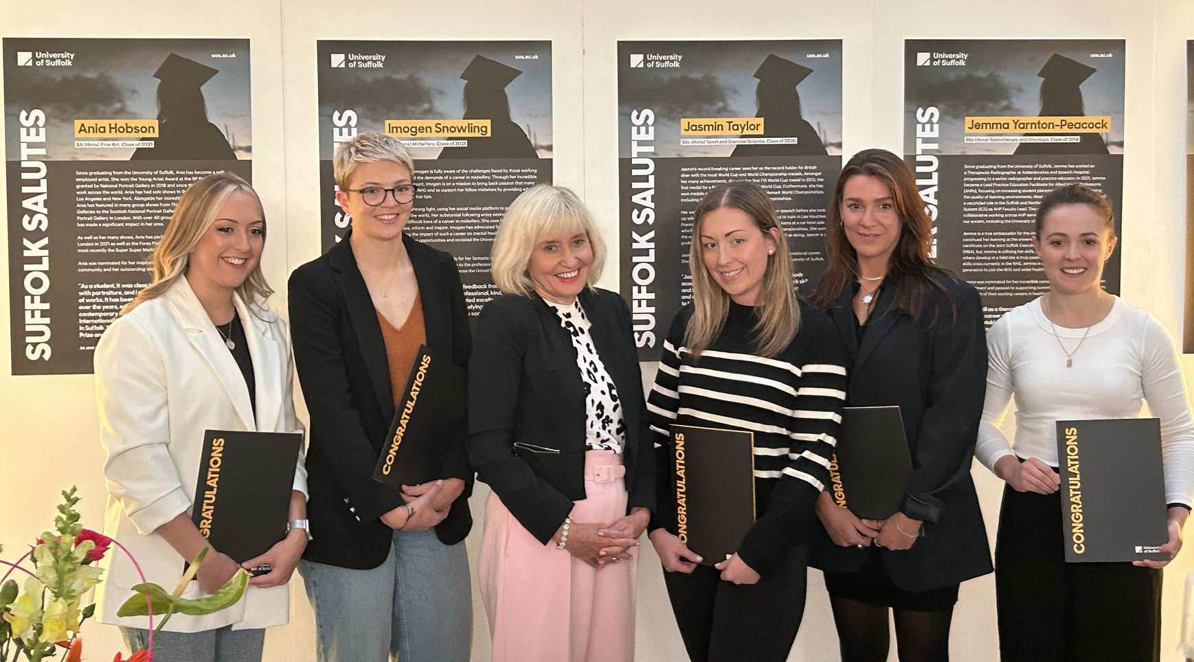 A group of women receiving achievement awards from University of Suffolk Vice-Chancellor