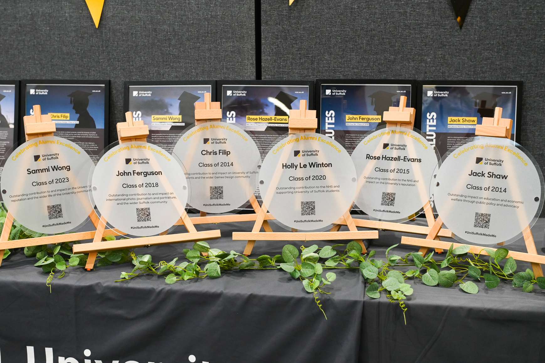 The six plaques honouring University of Suffolk alumni, displayed on a table