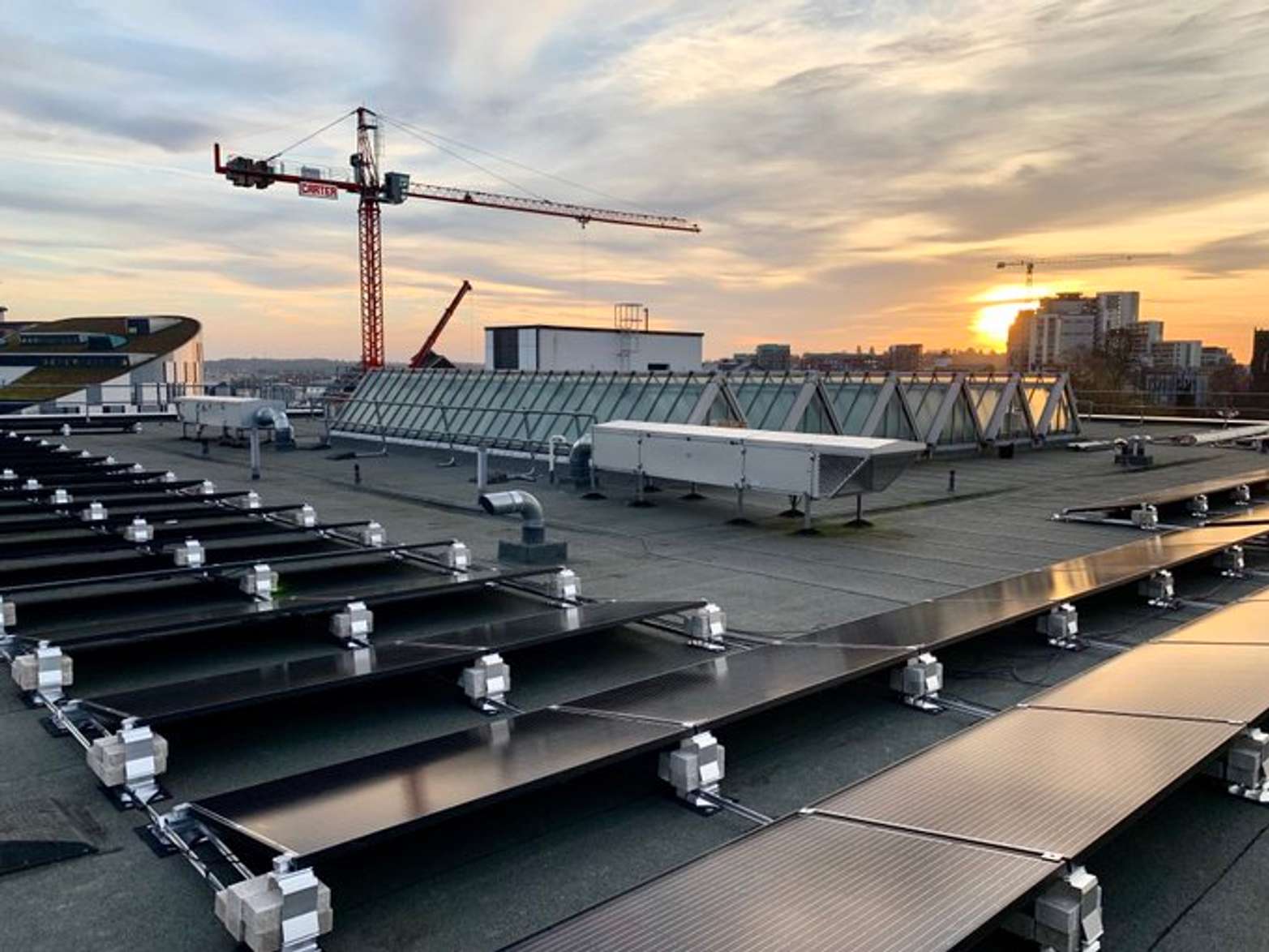 Solar panels on the roof of The Atrium Building, with a view out of the skyline