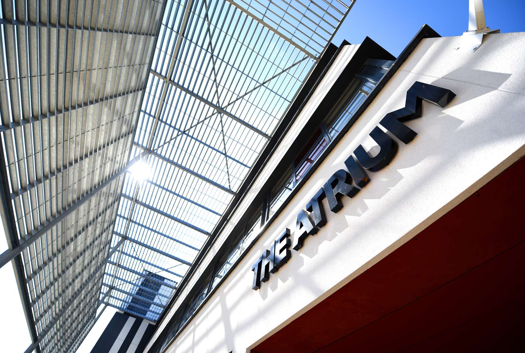 The outside of The Atrium building looking up at the sign