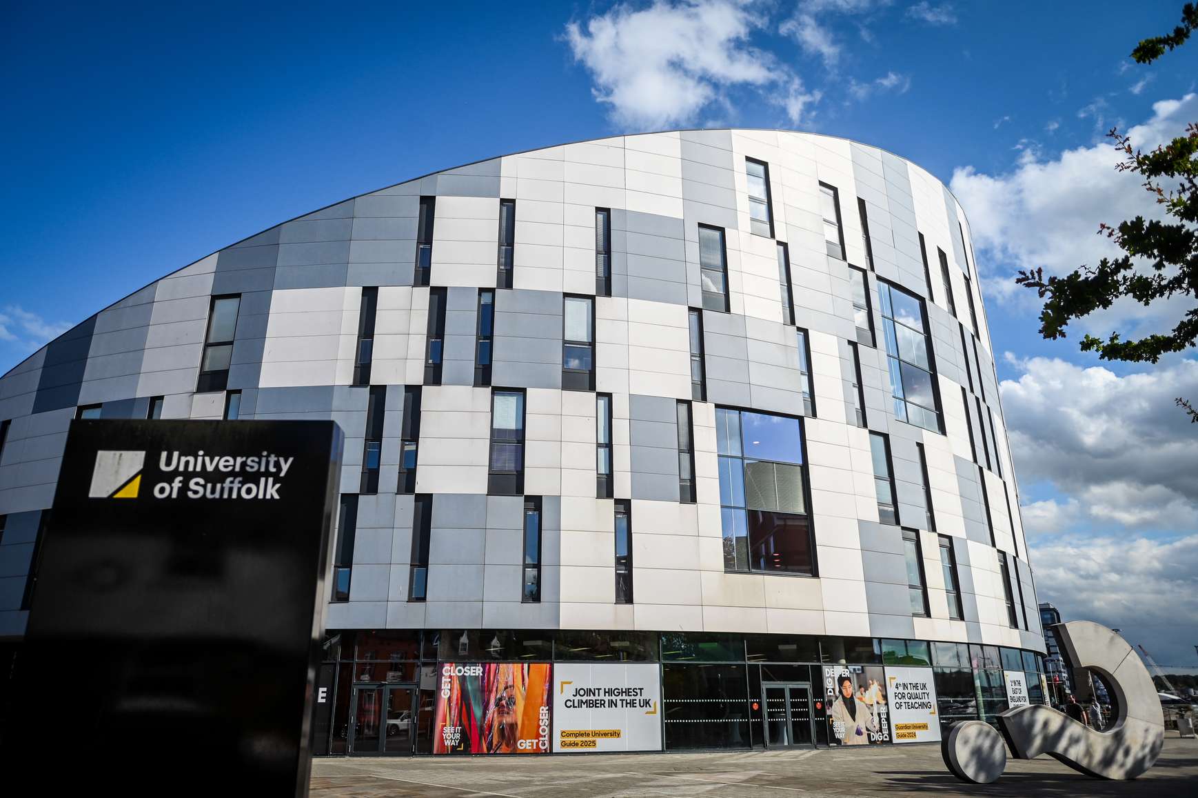 The exterior of the Waterfront Building with a sign which says 'University of Suffolk' visible
