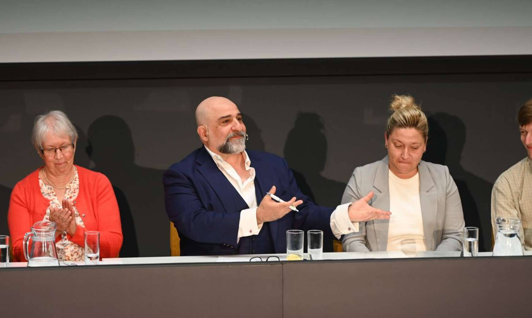 Host Omid Djallili speaking to delegates at the Spotlight Suffolk event, seated to his right is Prof Helen Langton and to his left is Sophie Alexander-Parker