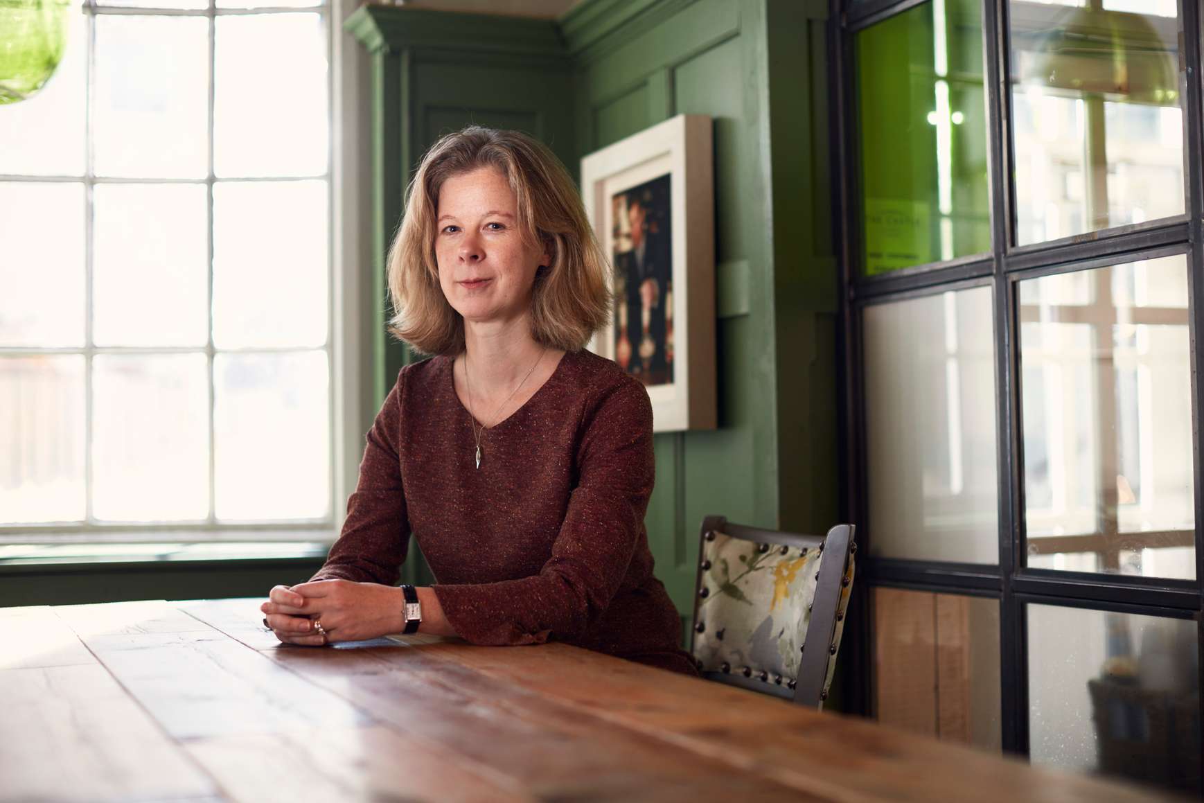 A photo of Professor Rachel Allen seated at a table. Prof Allen is the newly appointed Provost for the University.