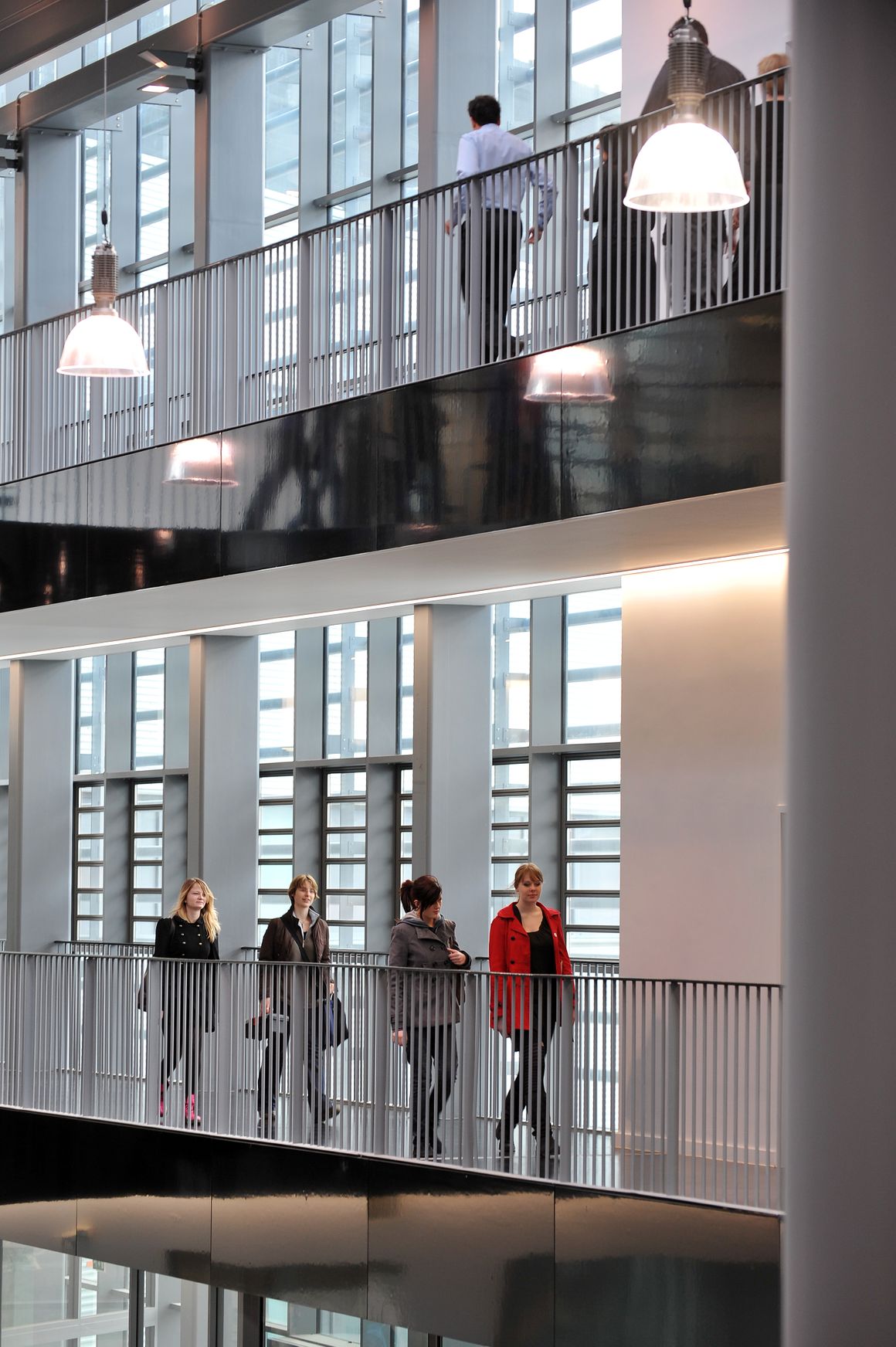 Students walking on a balcony inside Suffolk New College