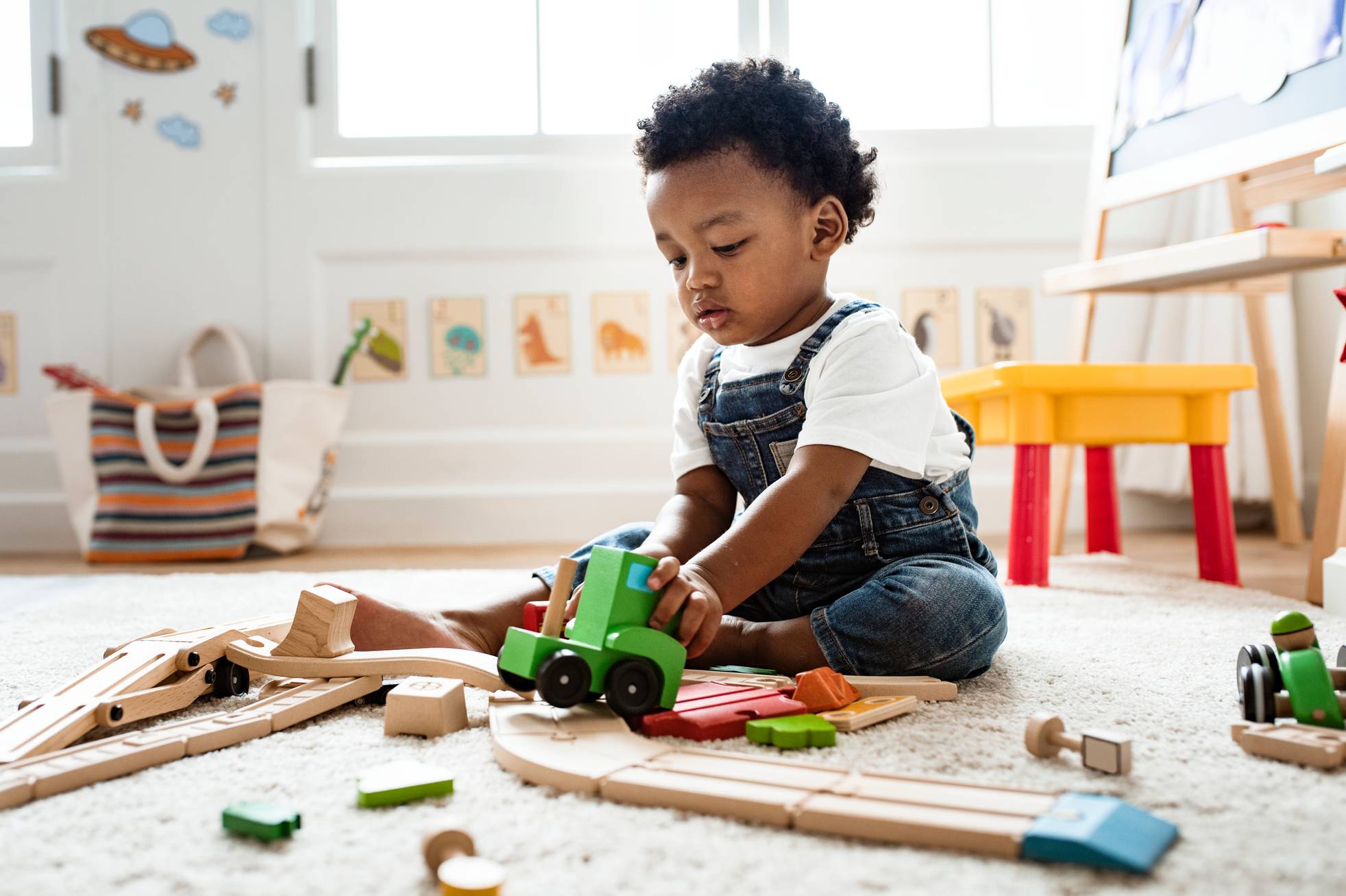 Toddler playing with wooden train