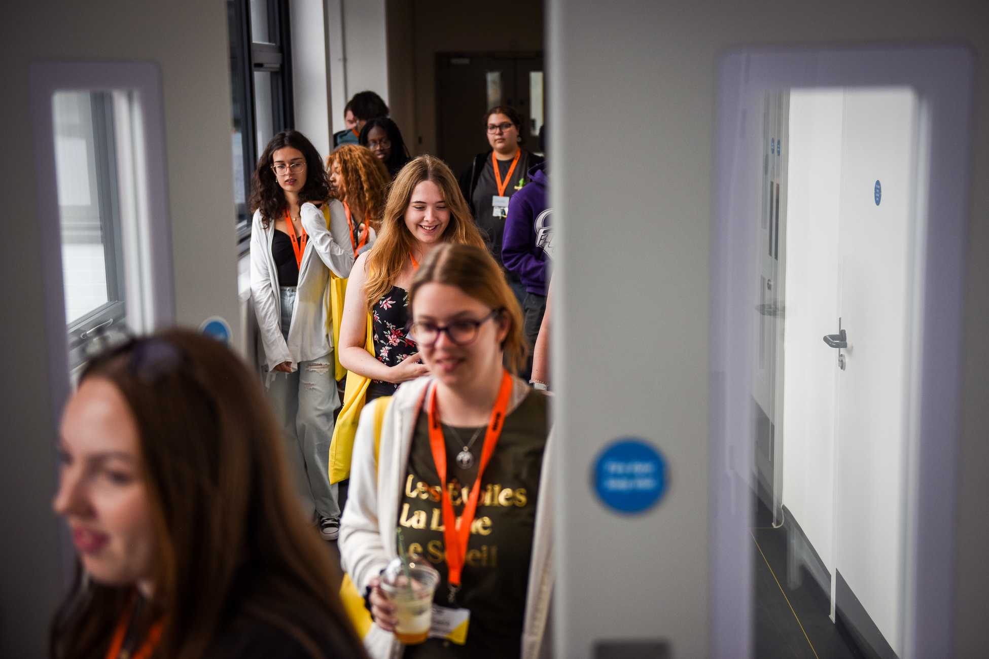 A group of students walking down a corridor