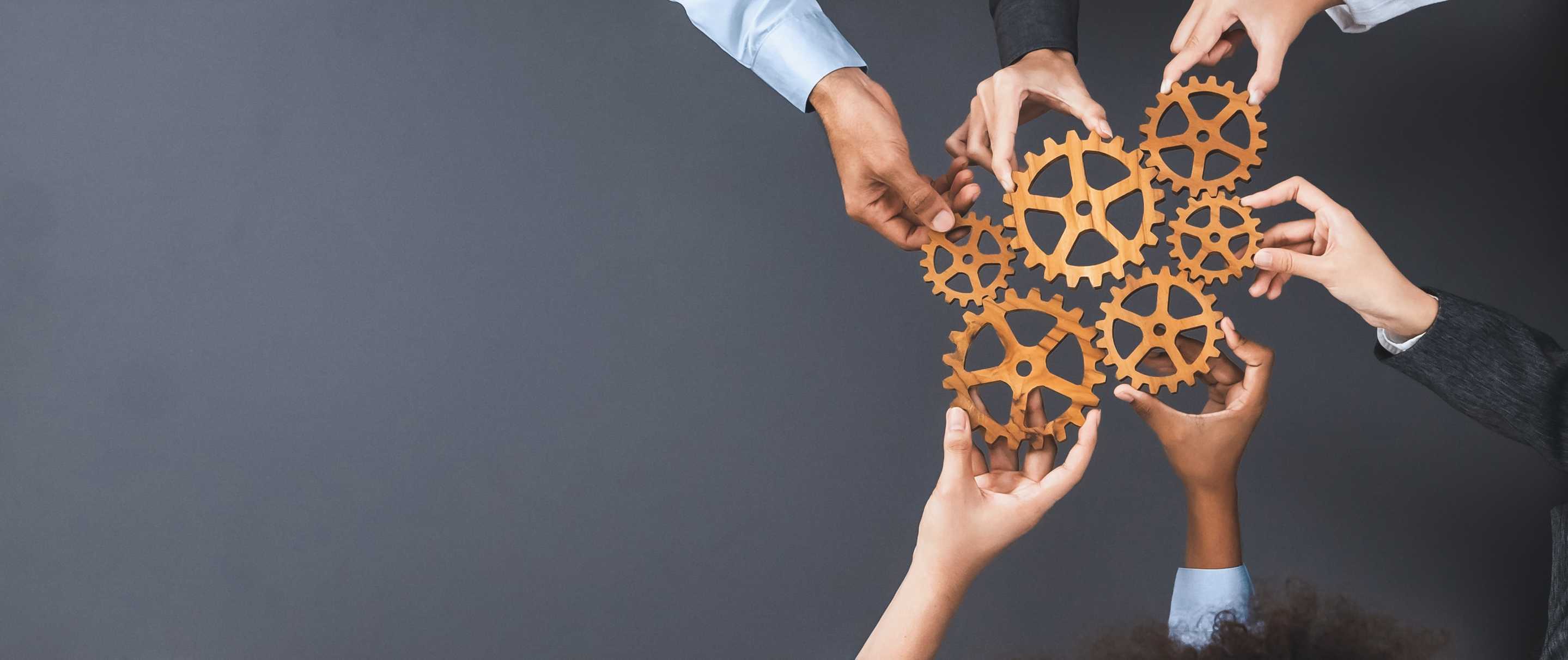 People holding cogs to connect