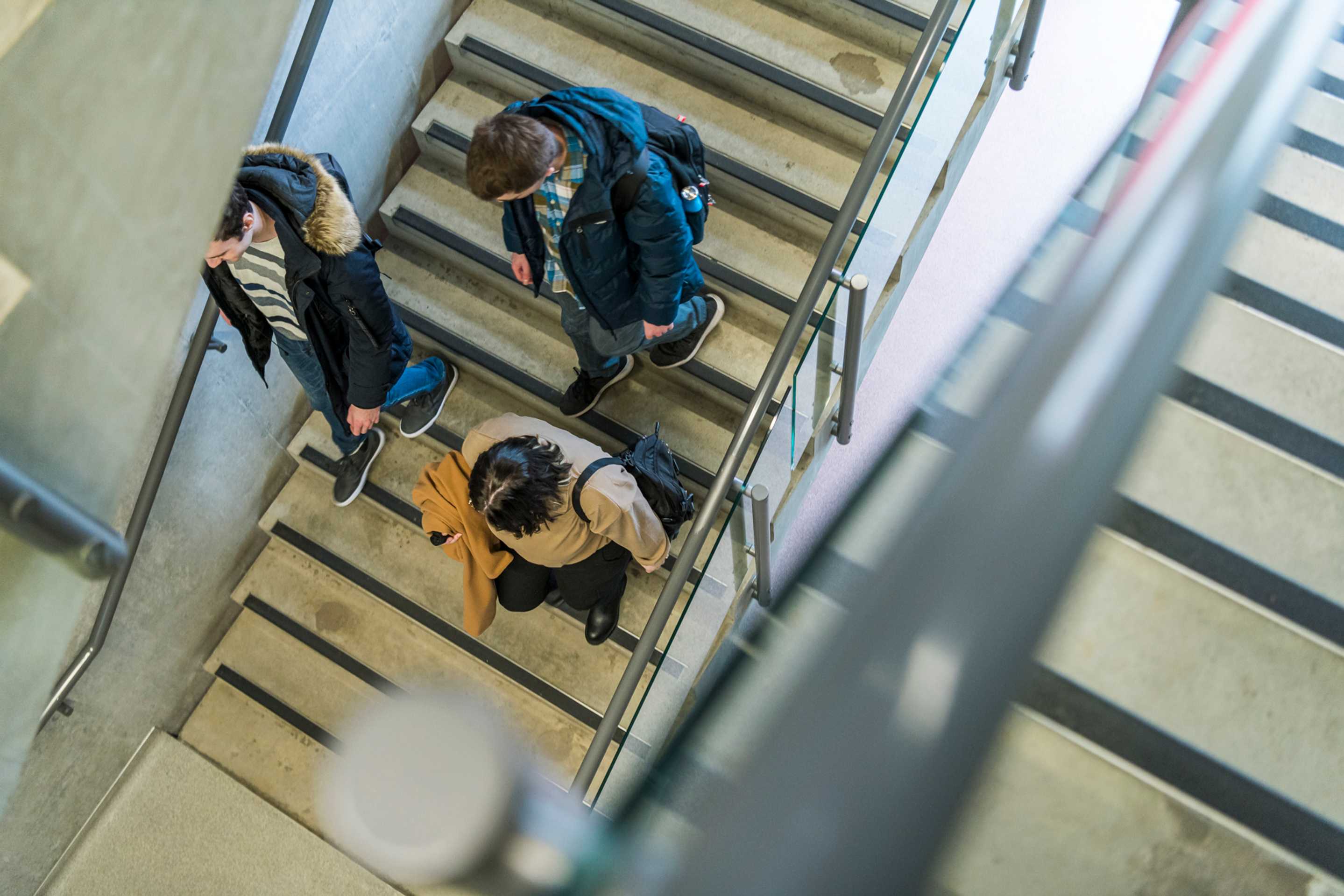 A group of students walking down a stairwell