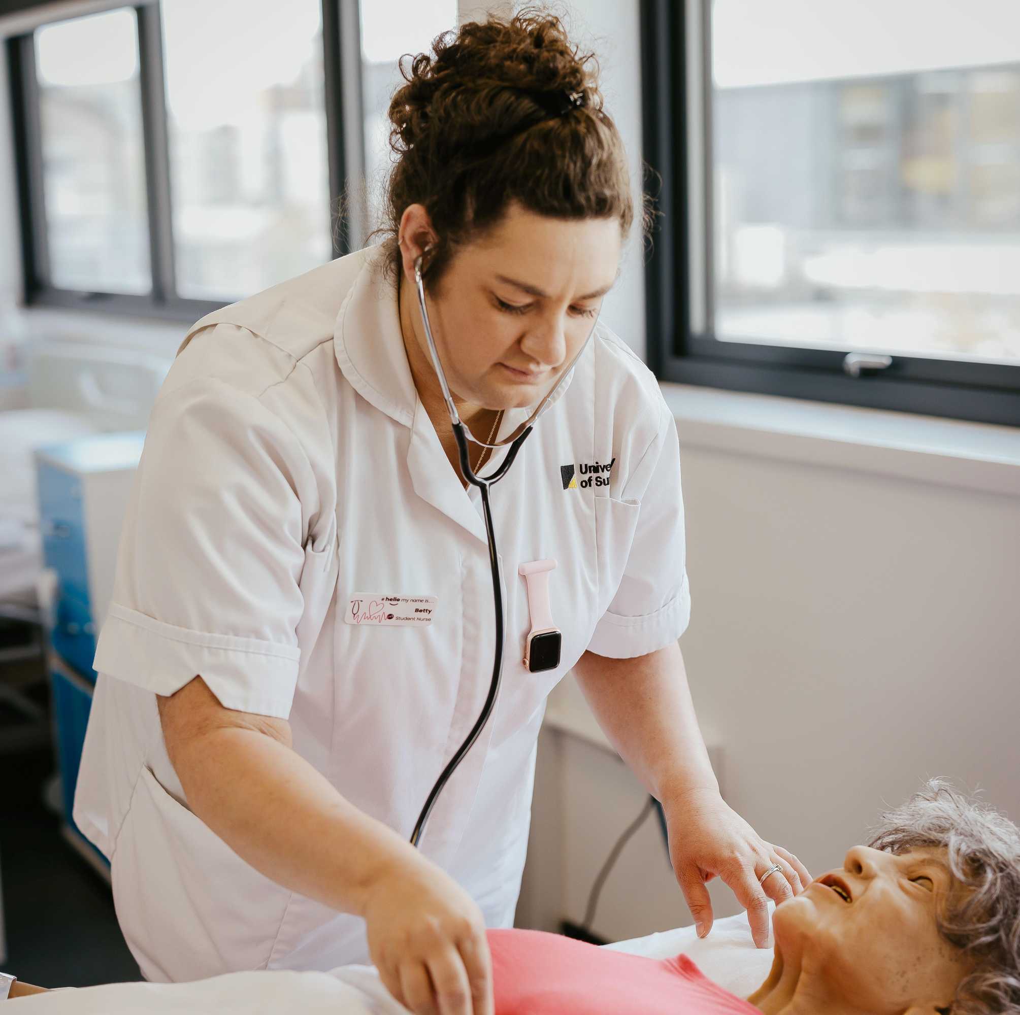 nursing student working on a simulated patient