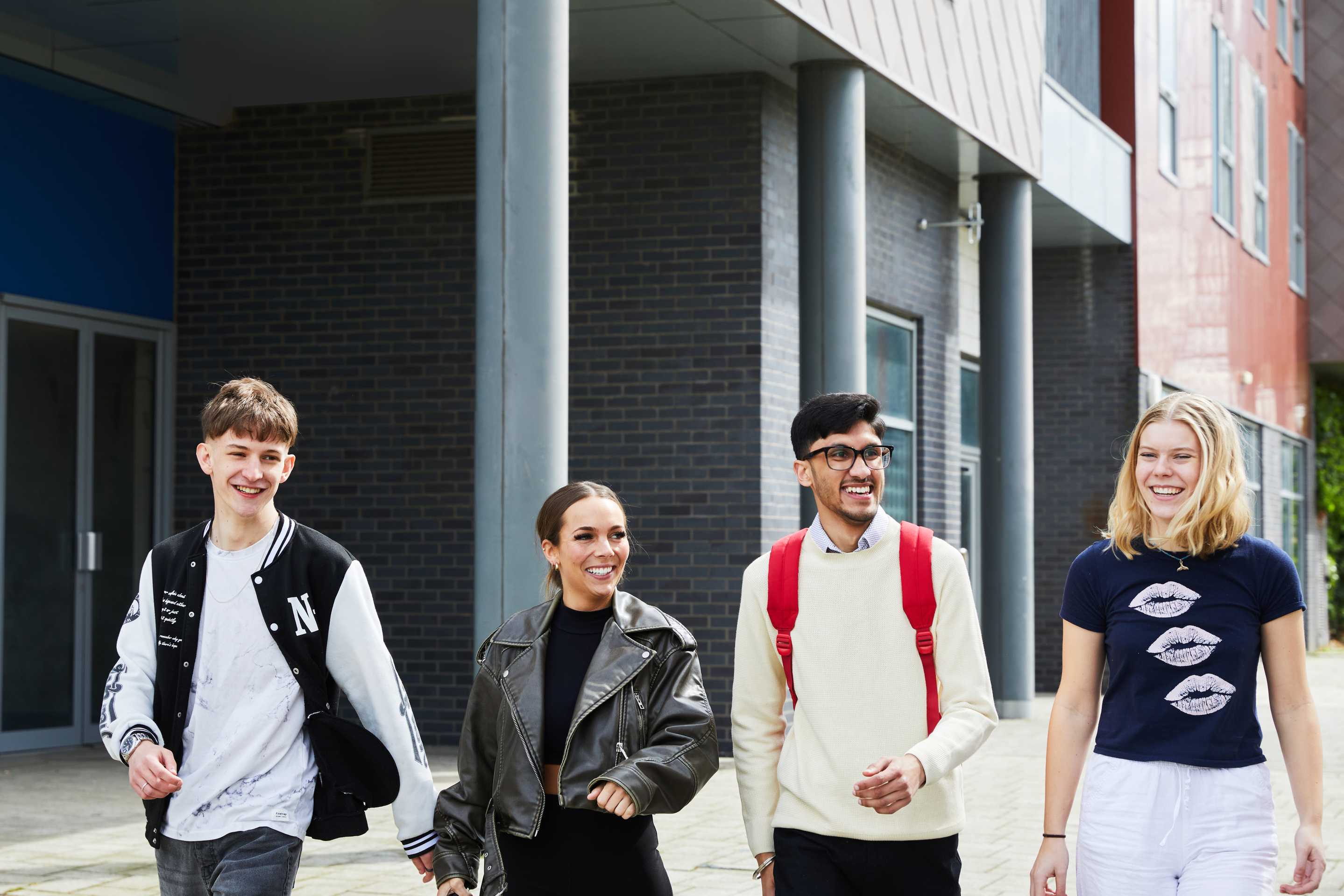 A group of students walking outside Athena Hall accommodation