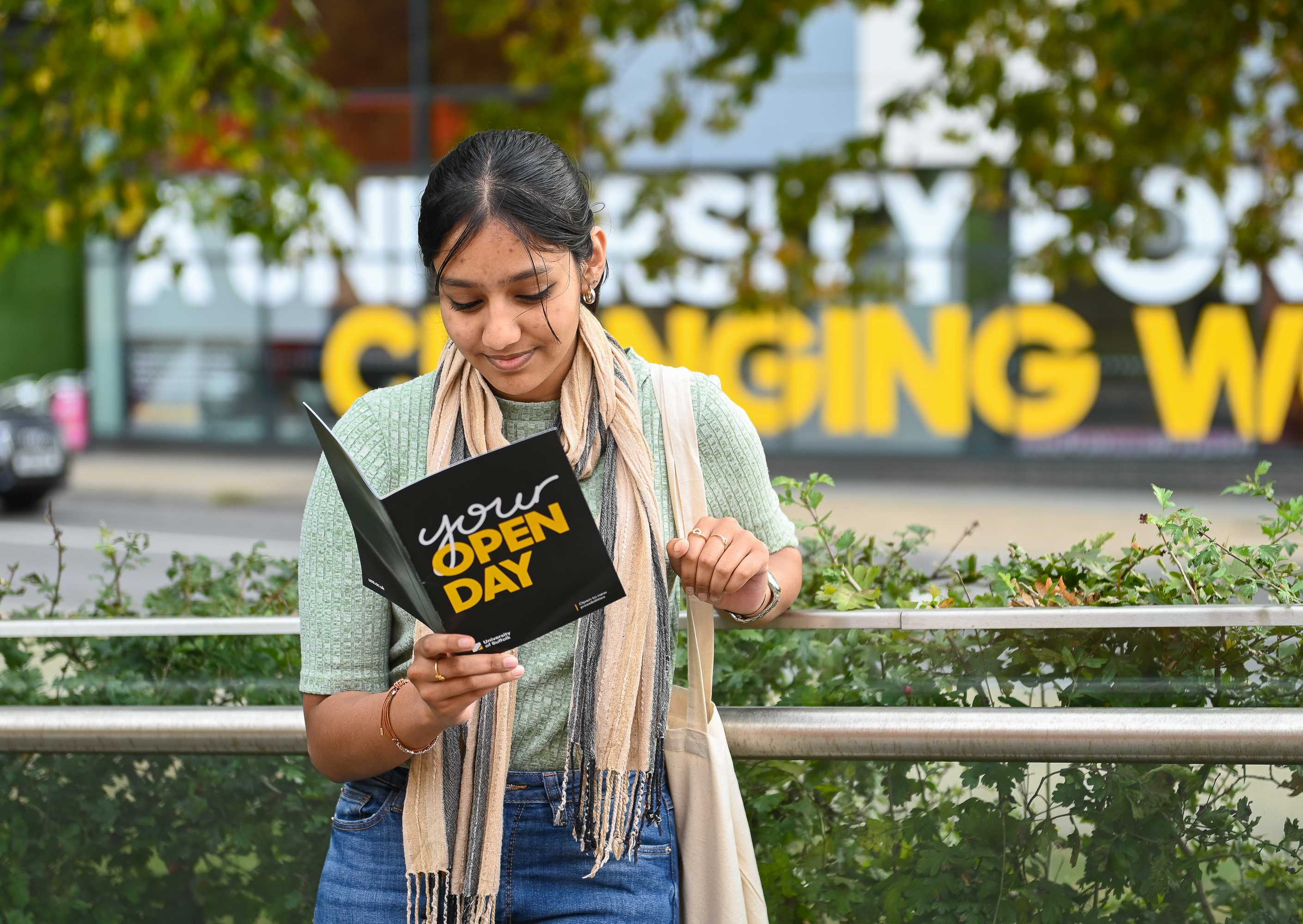 A student at an open day reads through the brochure