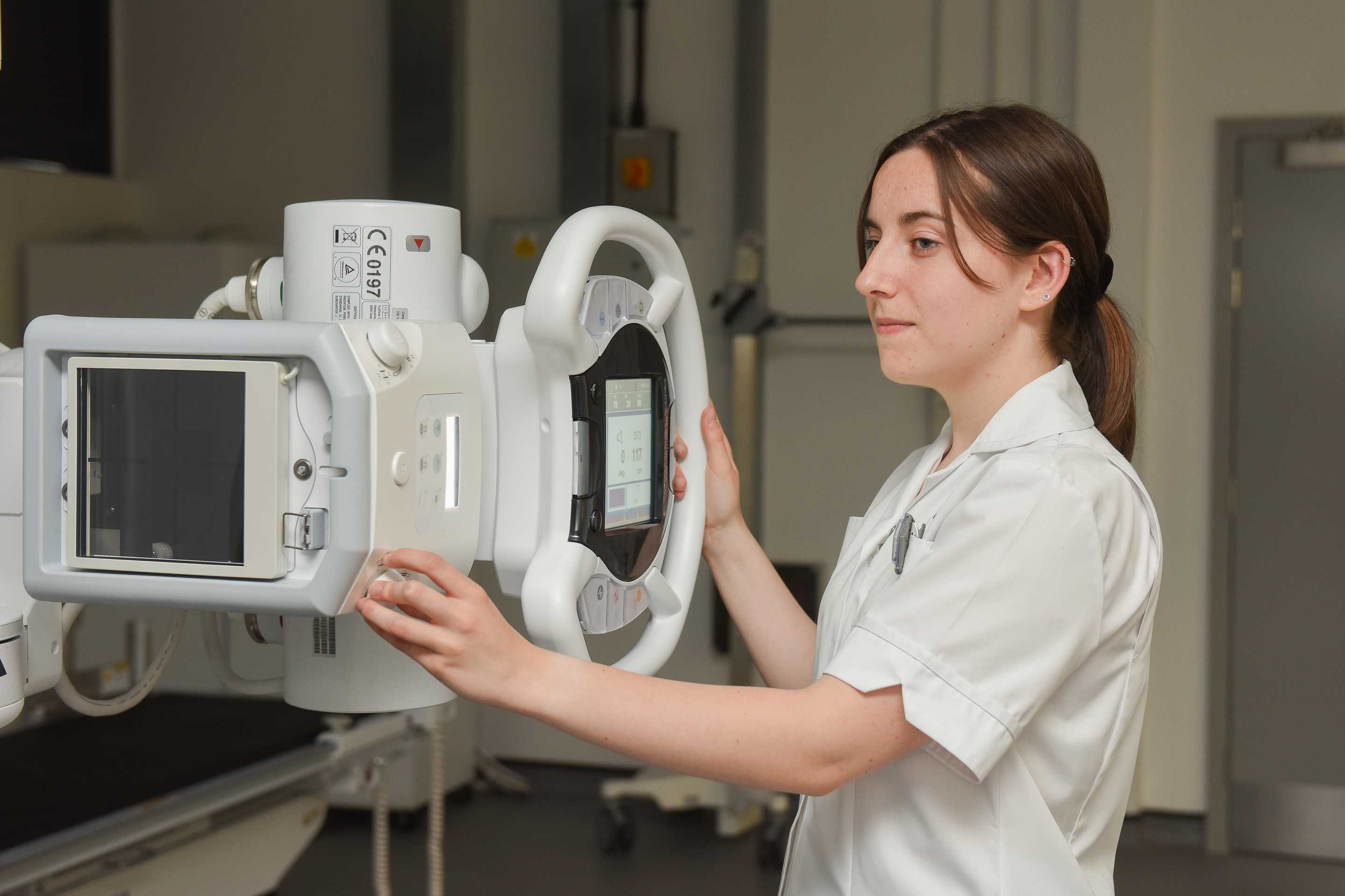 A student radiographer with x-ray machine