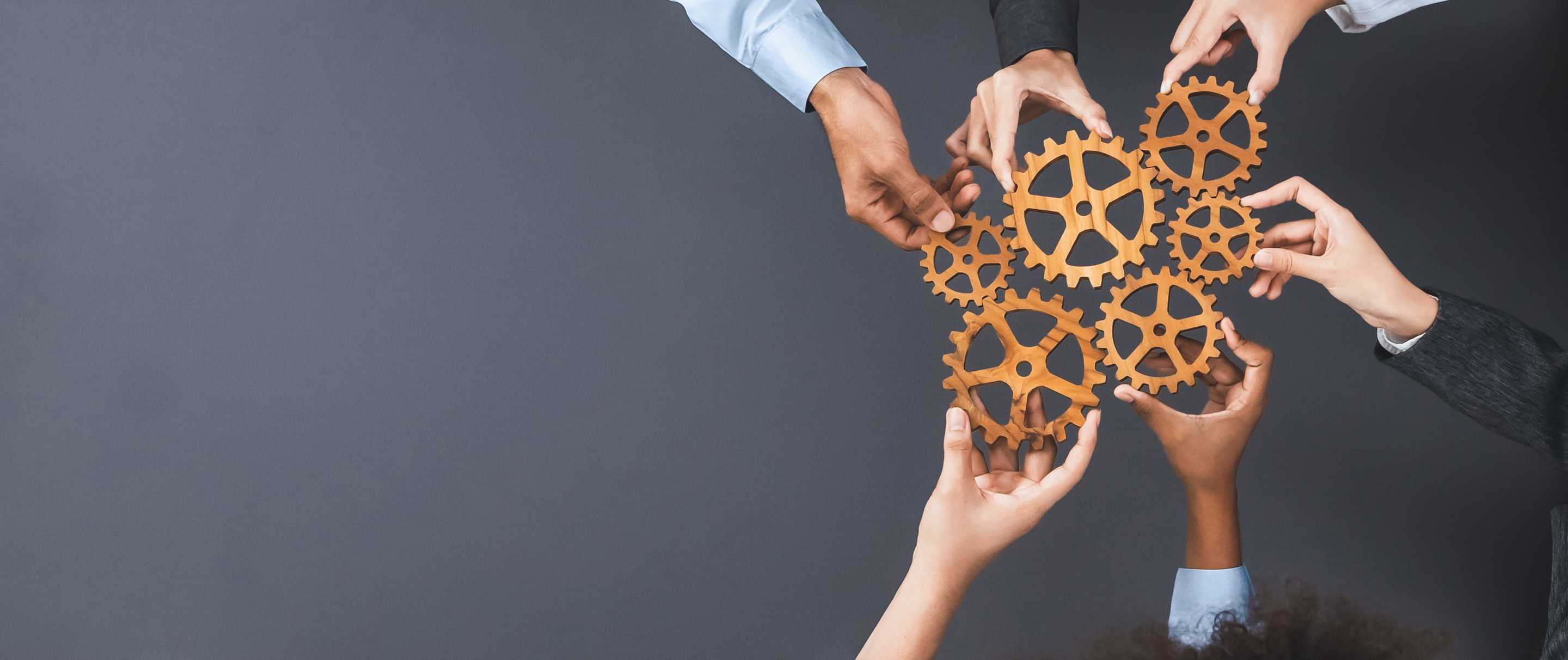 People holding cogs to connect