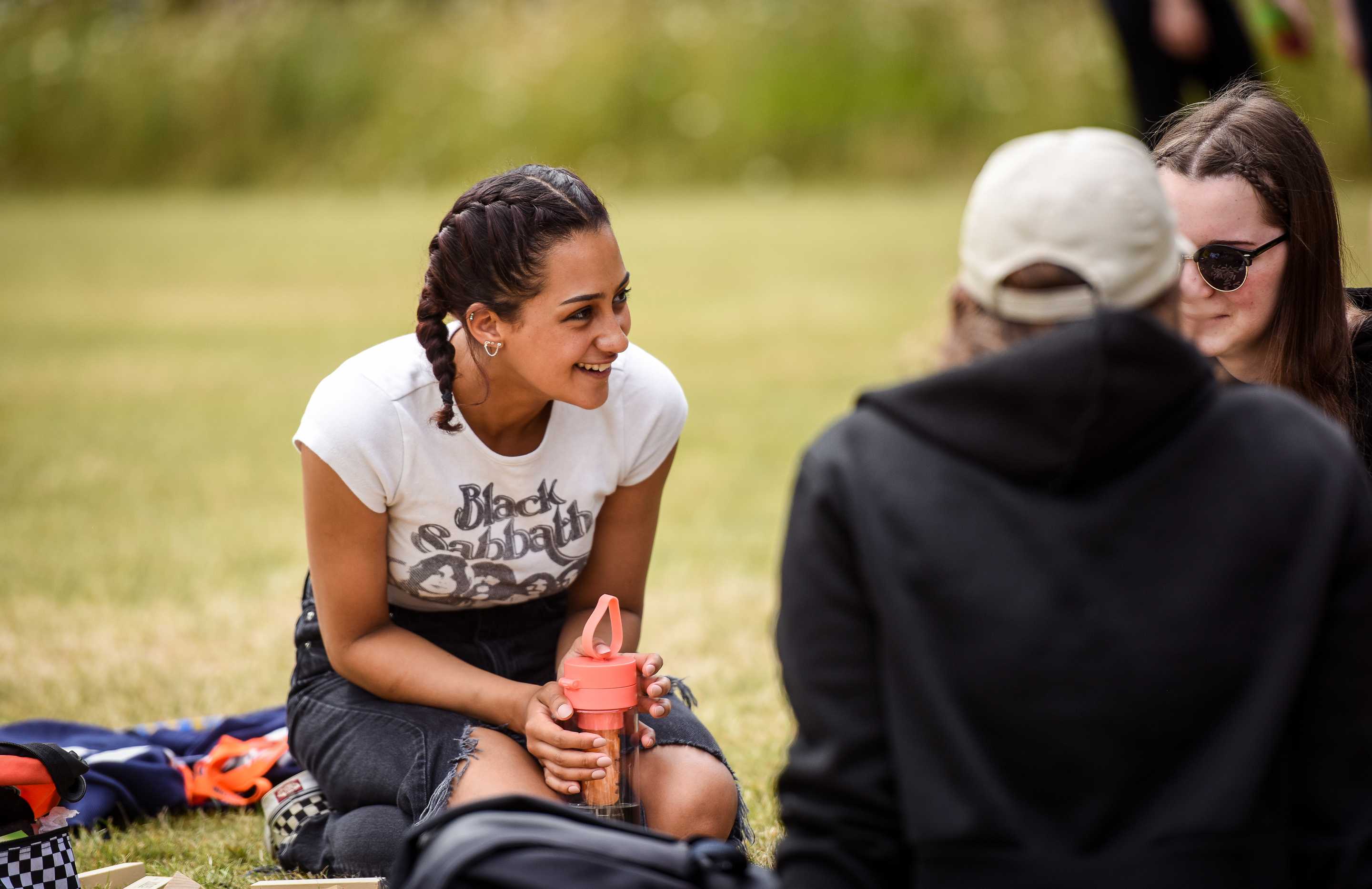 Young people sitting on grass in a park