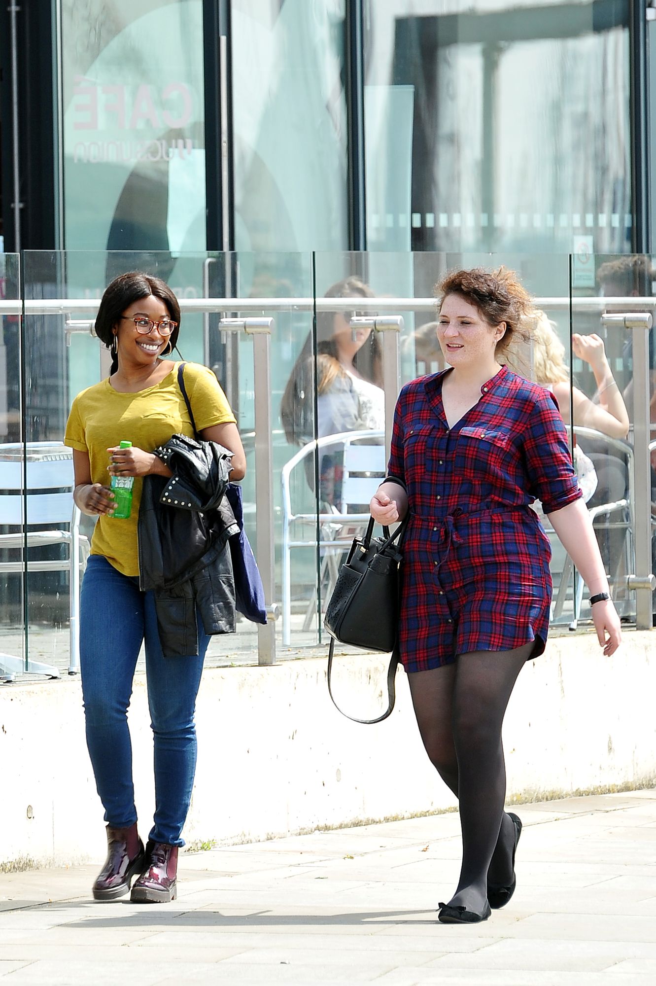 Two students walking on the waterfront plaza