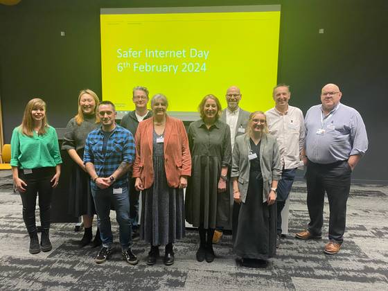 A group photo of the speakers at the Safer Internet Day event gathered at the front of the lecture theatre