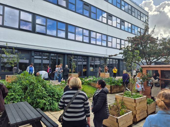 group of people looking around an open space an allotment