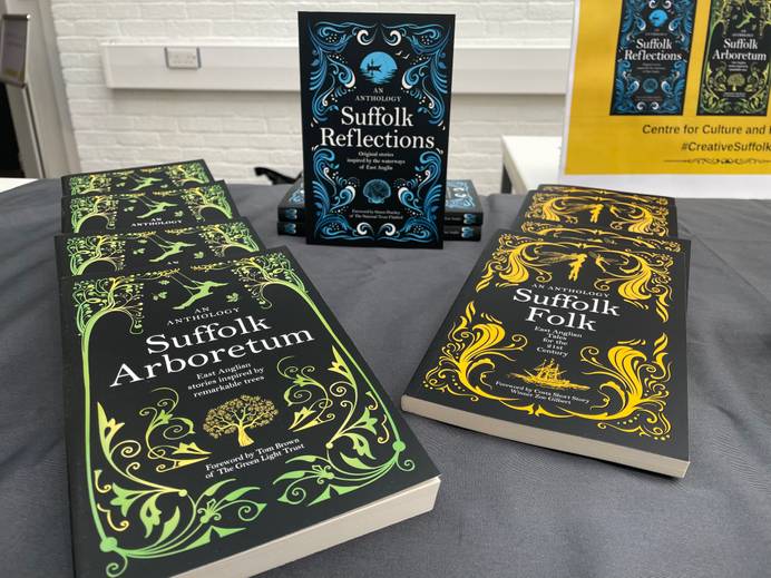 Copies of the three books, Suffolk Reflections, Suffolk Arboretum and Suffolk Folk, arranged on a display on a table