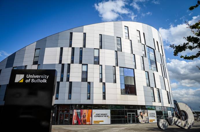 The exterior of the Waterfront Building with a sign which says 'University of Suffolk' visible