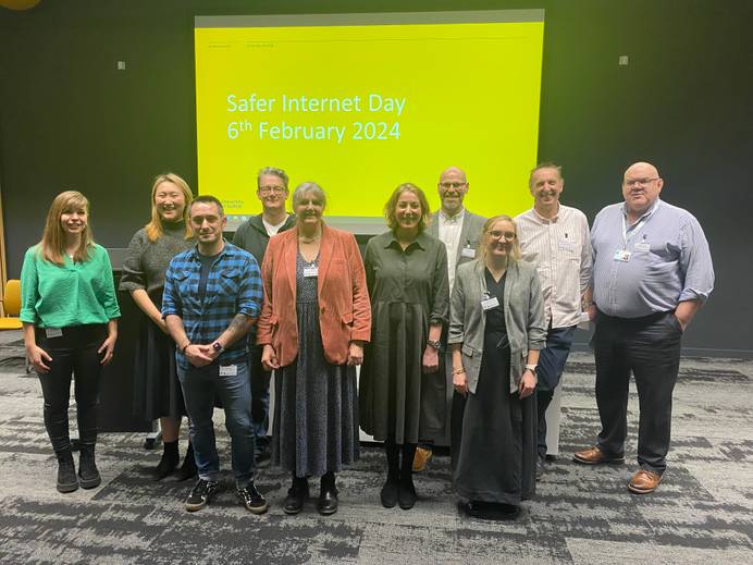 A group photo of the speakers at the Safer Internet Day event gathered at the front of the lecture theatre