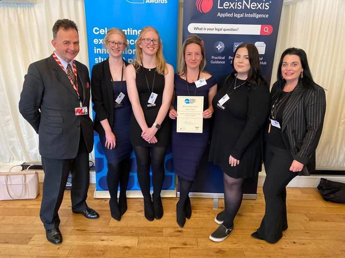 Staff and students from the Legal Advice Centre holding a certificate for the LawWorks and Attorney General Student Pro Bono Awards