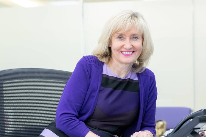 A photo of Jenny Higham, the new Vice-Chancellor joining later in 2024, seated at a chair and smiling