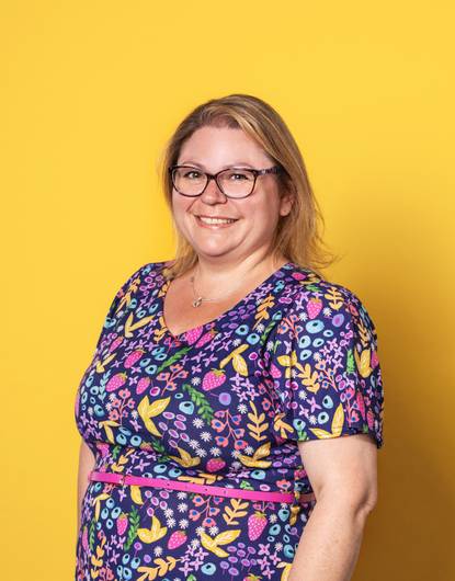 Midwifery lecturer Karen Henry with yellow background