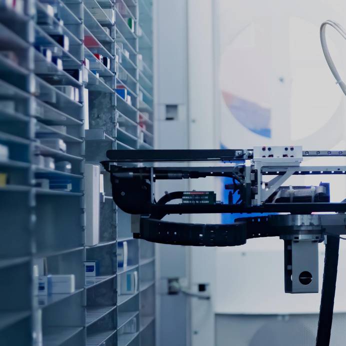 Modern pharmacy storage room with a robot hand arranging and storing out drugs in a pharmacy