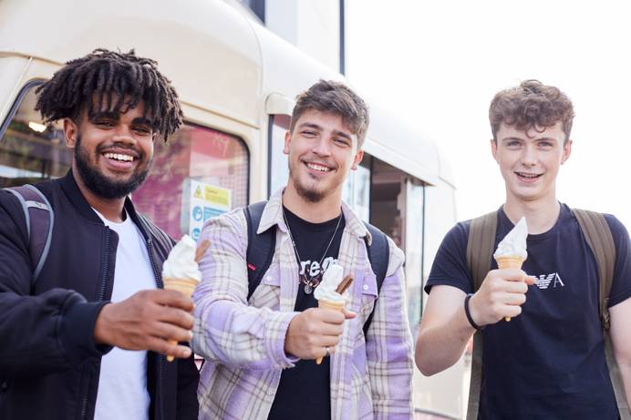 Students standing holding ice creams