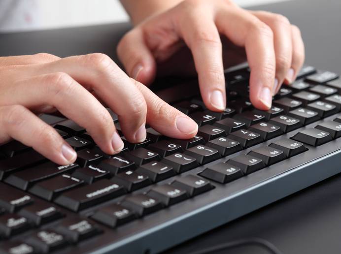 Close-up of someone typing on the keyboard