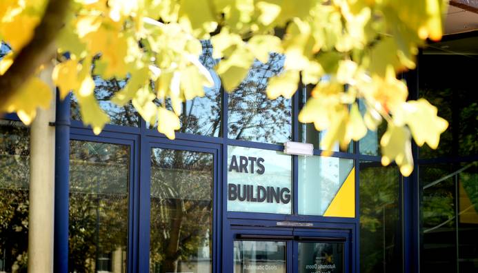 exterior of university building with tree in foreground